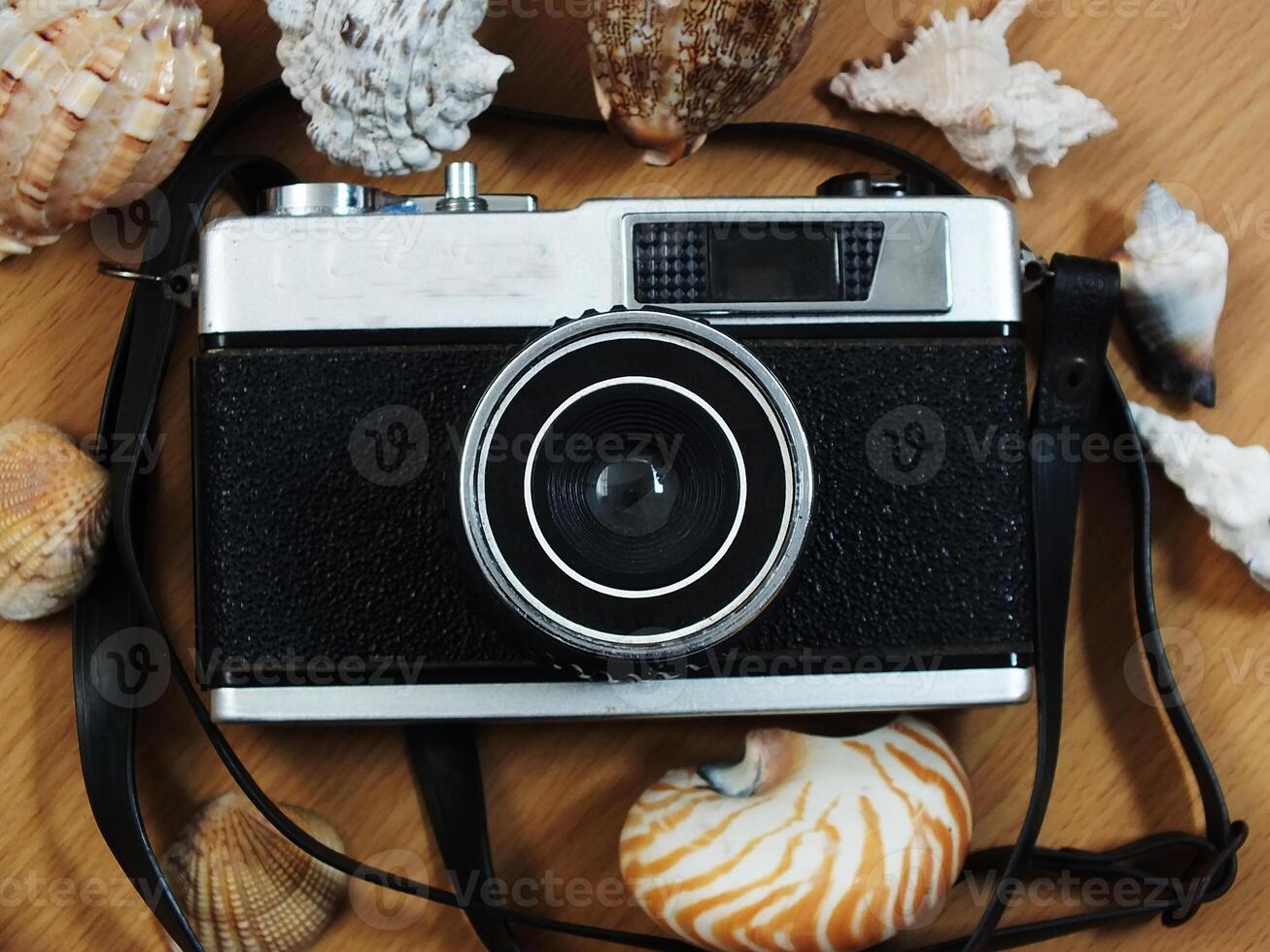 old vintage camera gear on wooden table background. top view, flat lay. Retro vintage concept. Travel and journey design element photo