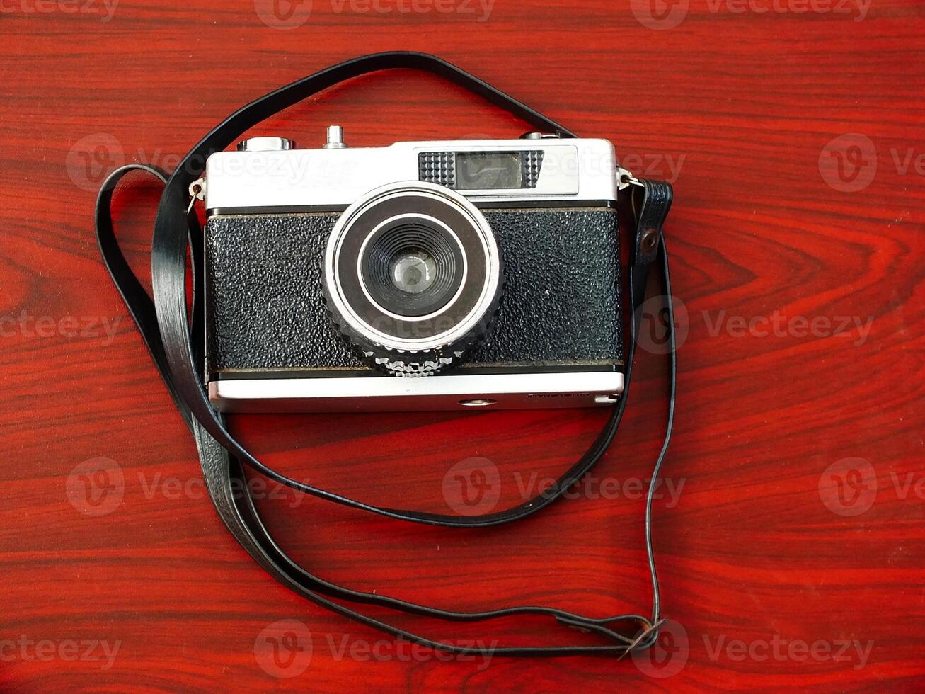 old vintage camera gear on wooden table background. top view, flat lay. Retro vintage concept. Travel and journey design element photo