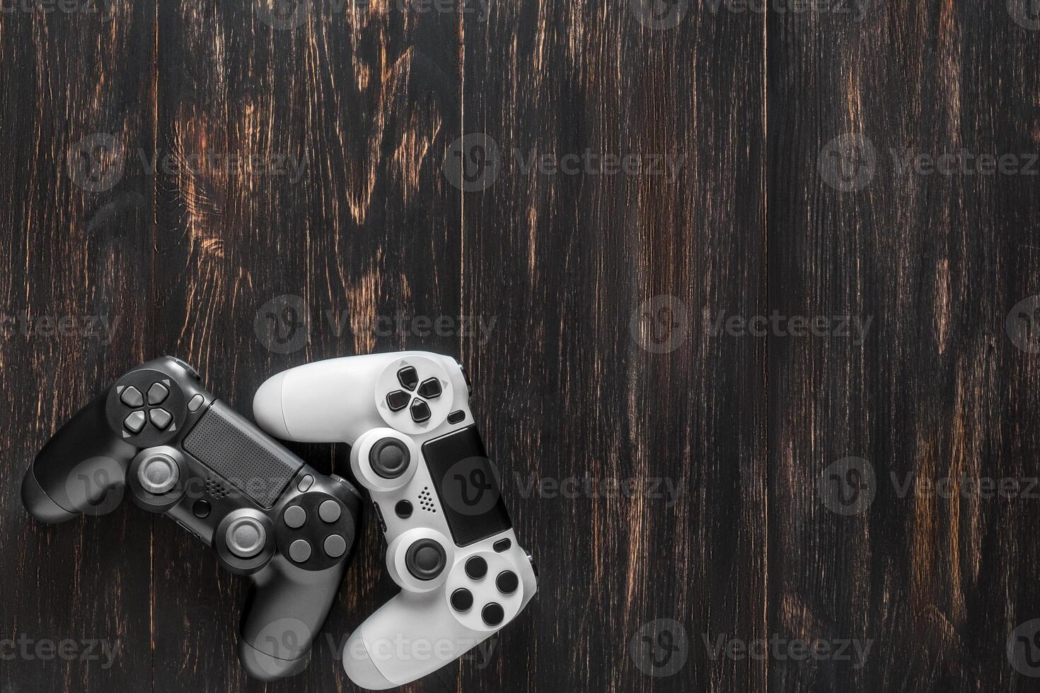 black and white modern gamepads on a dark background photo