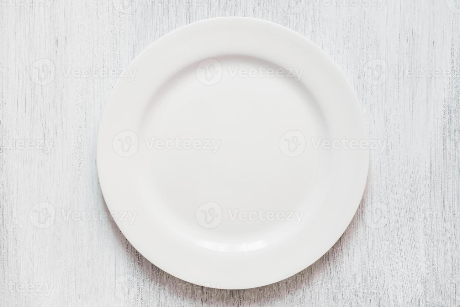 White round plate on white background. Empty white plate on white background. photo