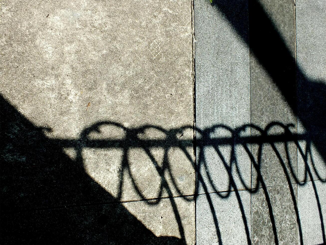 abstract background textured of a random shadow on an pavement pedestrian. photo