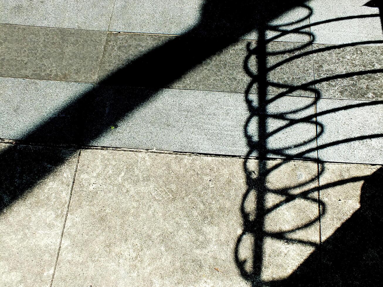 abstract background textured of a random shadow on an pavement pedestrian. photo