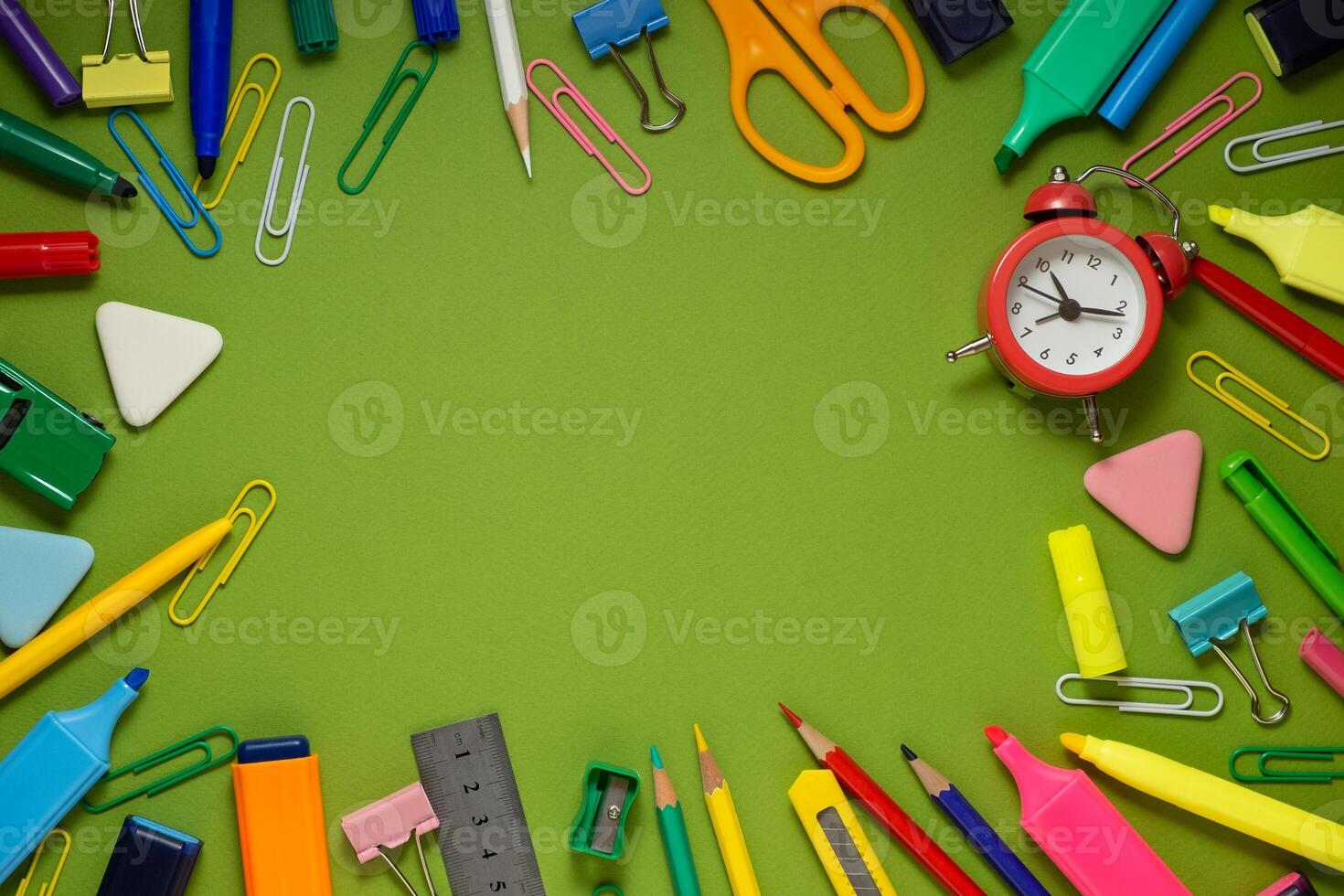School office supplies on a desk with copy space. Back to school concept. School supplies on green background. Back 2 school concept photo