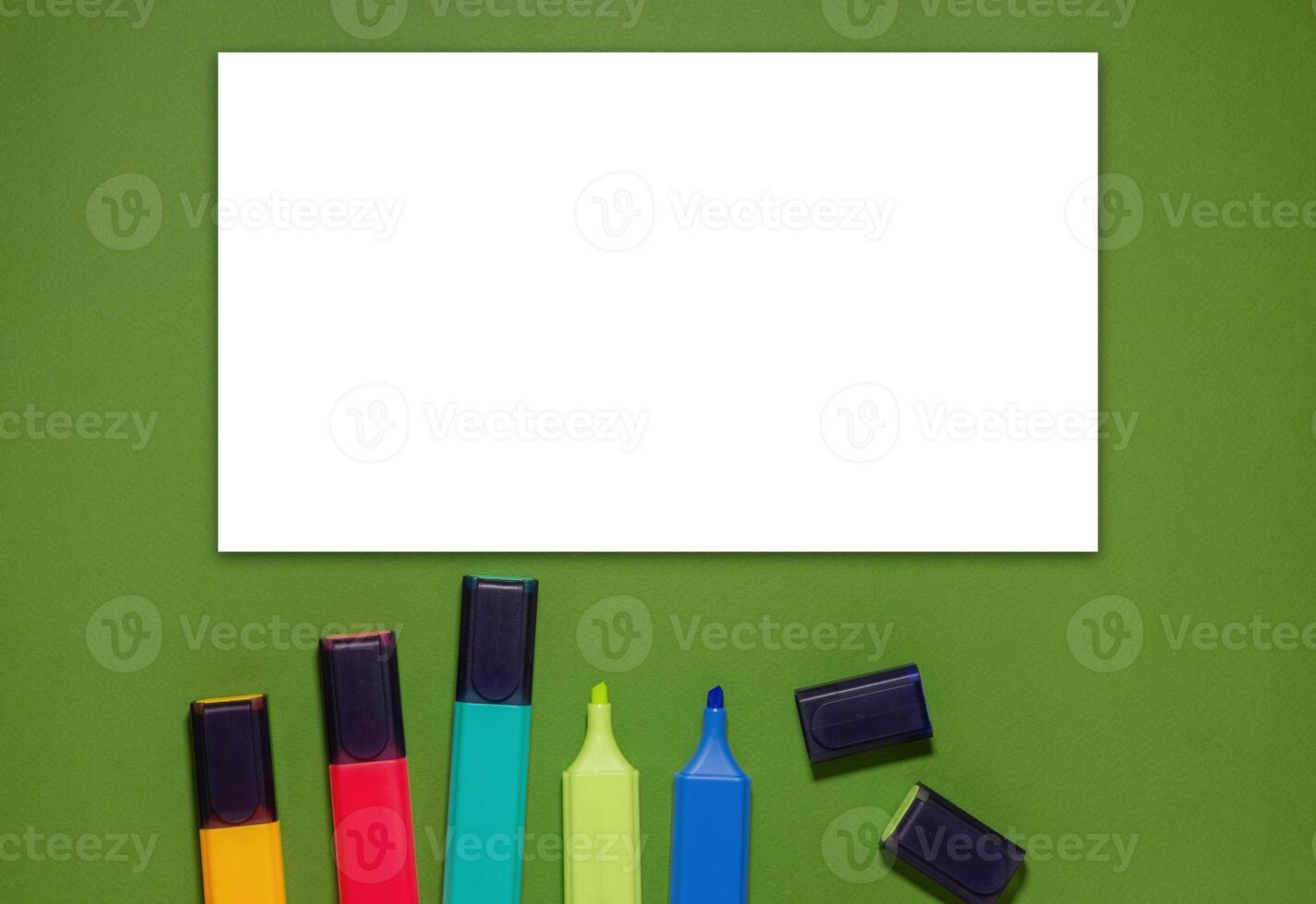 Multi-colored markers on a green background. Back to school concept. photo