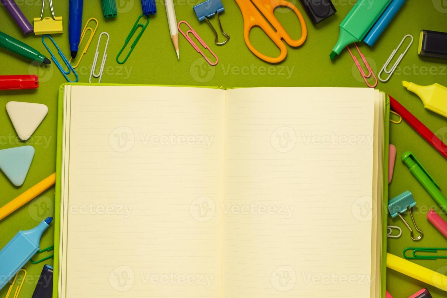 School office supplies on a desk with copy space. Back to school concept. School supplies on green background. Back 2 school concept photo