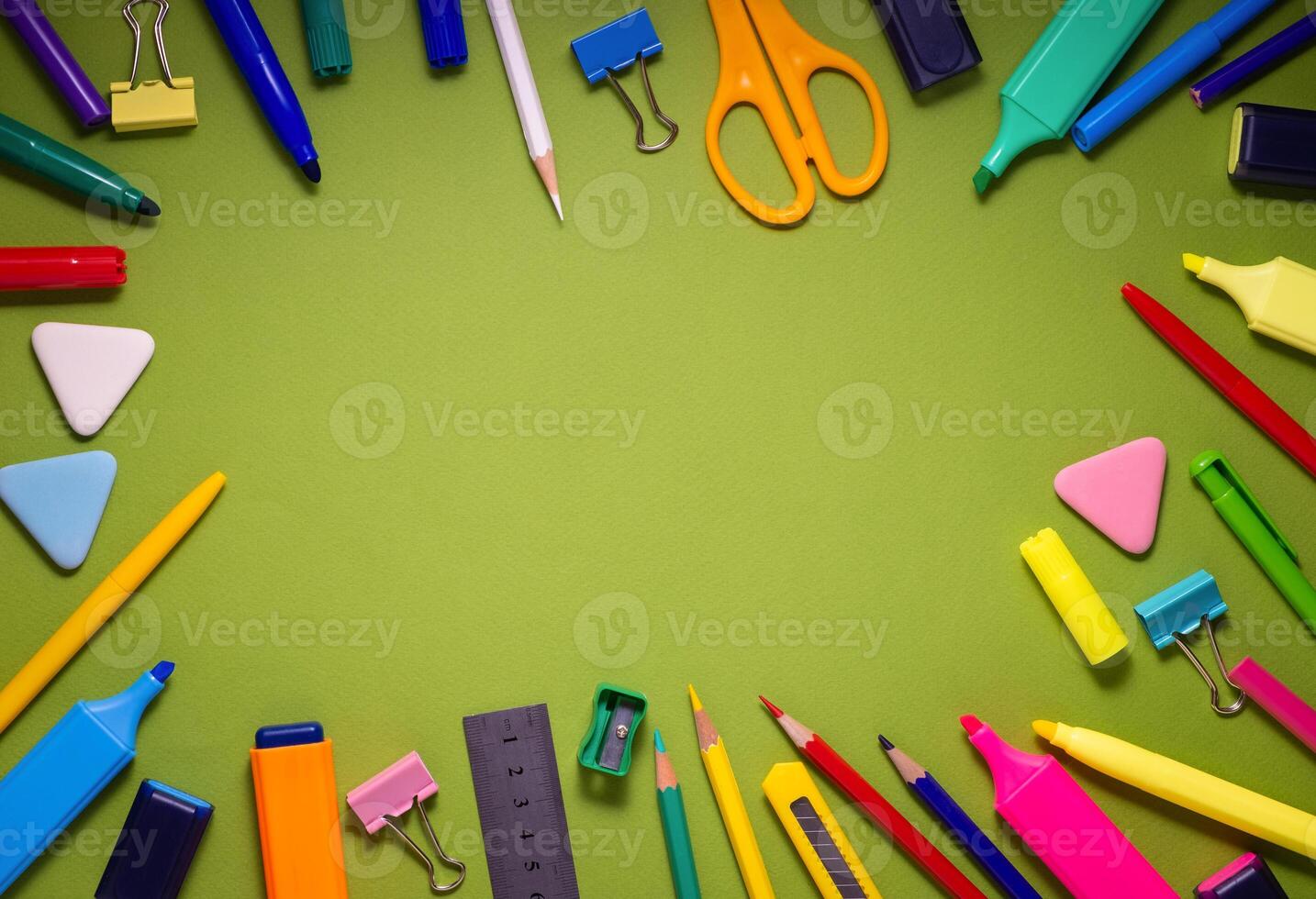 School office supplies on a desk with copy space. Back to school concept. School supplies on green background. Back 2 school concept photo