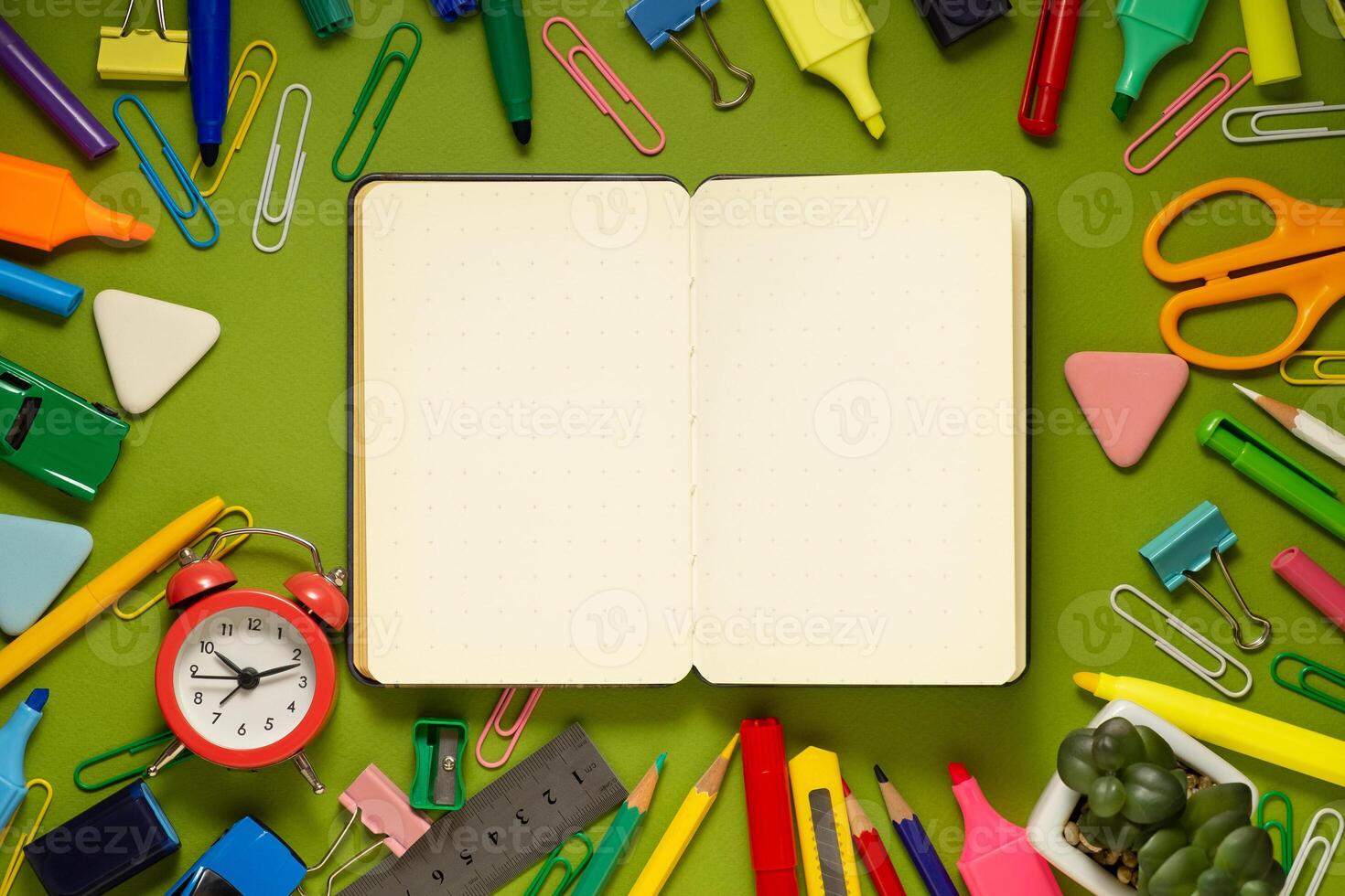 School office supplies on a desk with copy space. Back to school concept. School supplies on green background. Back 2 school concept photo