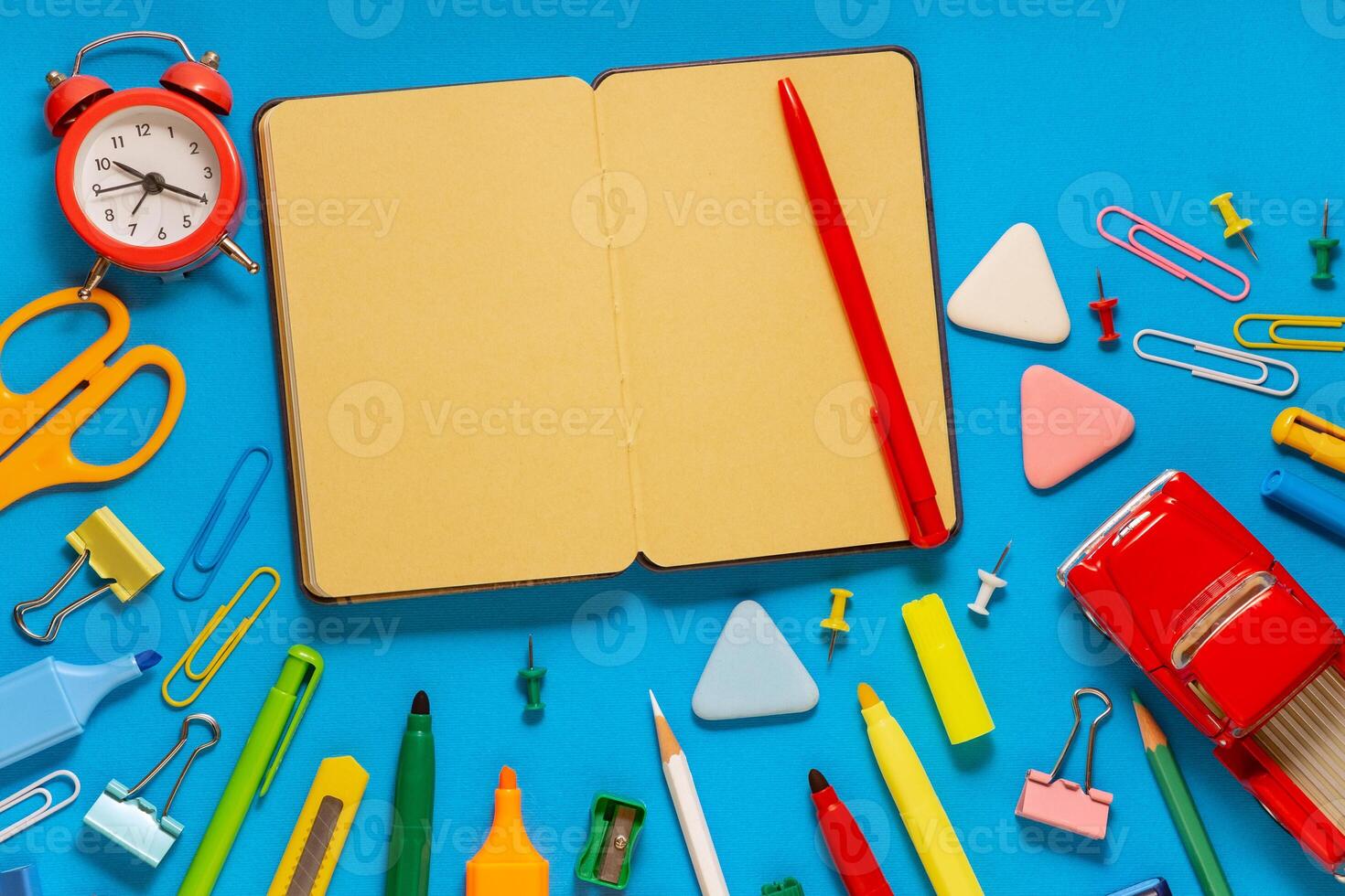 School office supplies on a desk with copy space. Back to school concept. School supplies on blue background. Back 2 school concept photo