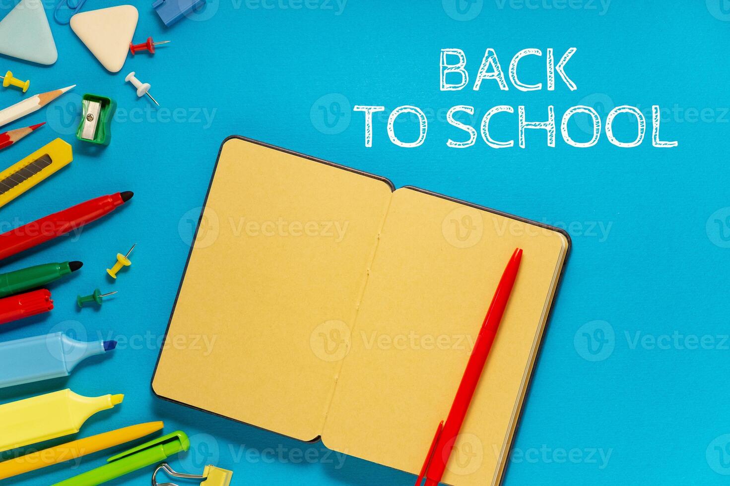 School office supplies on a desk with copy space. Back to school concept. School supplies on blue background. Back 2 school concept photo