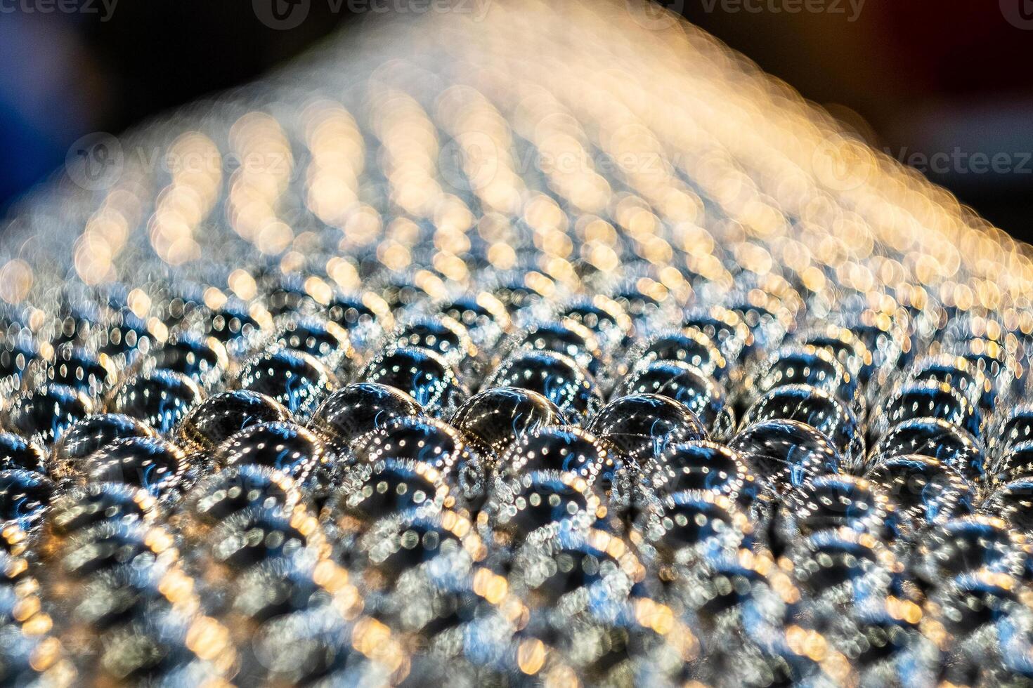 Close-up of metal balls in the field of sharpness. Blurred background with pronounced bokeh. photo