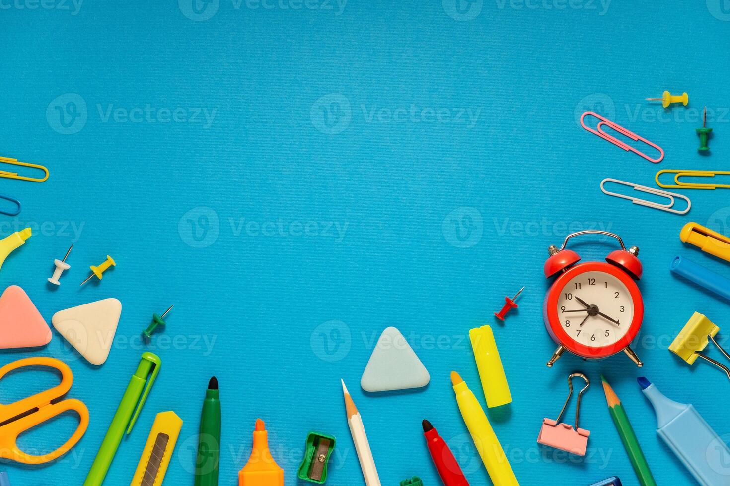 School office supplies on a desk with copy space. Back to school concept. School supplies on blue background. Back 2 school concept photo