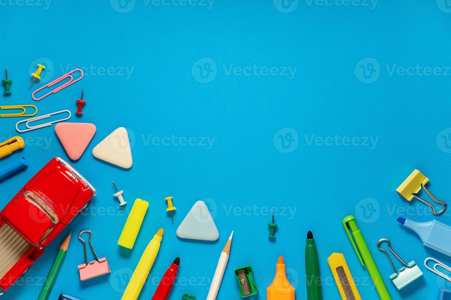 School office supplies on a desk with copy space. Back to school concept. School supplies on blue background. Back 2 school concept photo