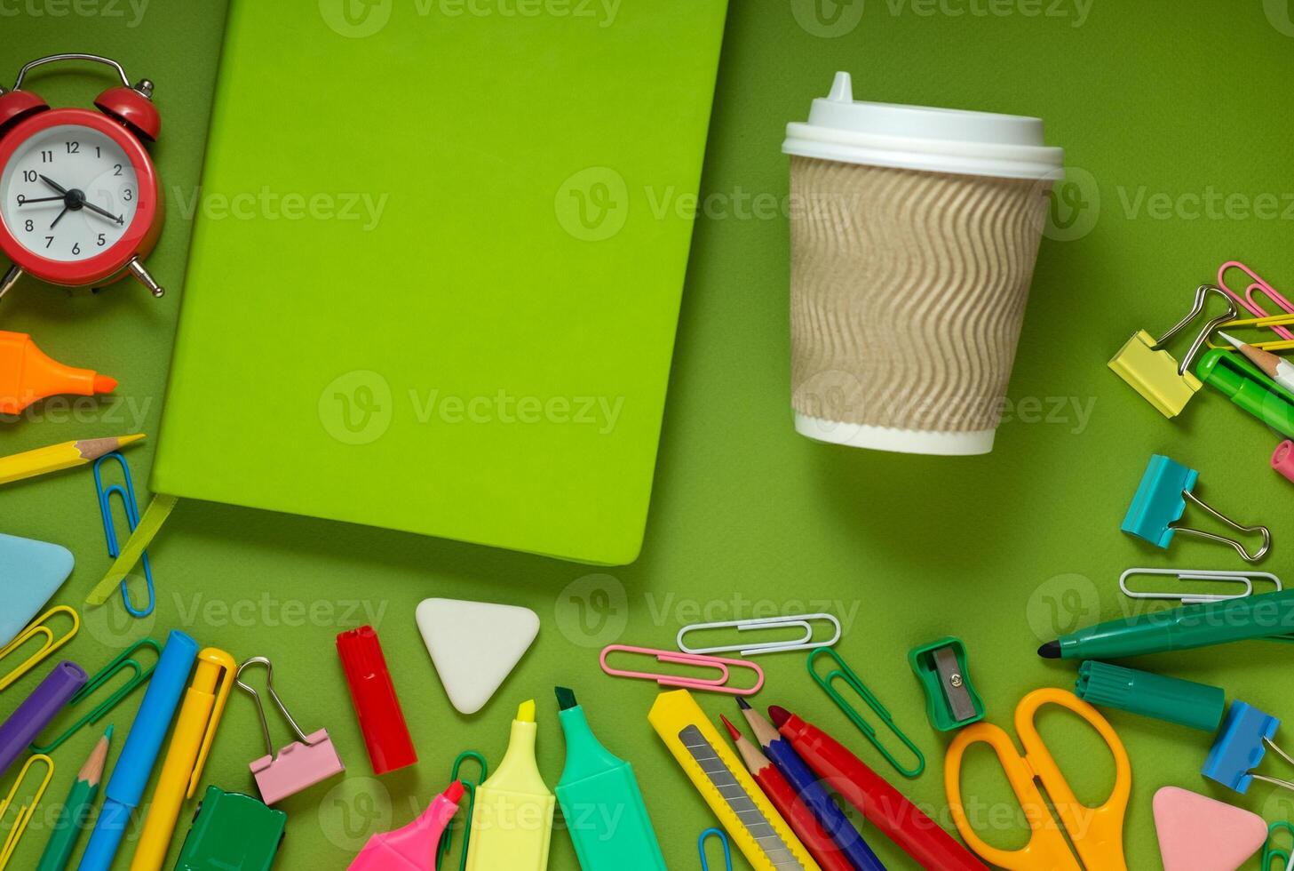 School office supplies on a desk with copy space. Back to school concept. School supplies on green background. Back 2 school concept photo
