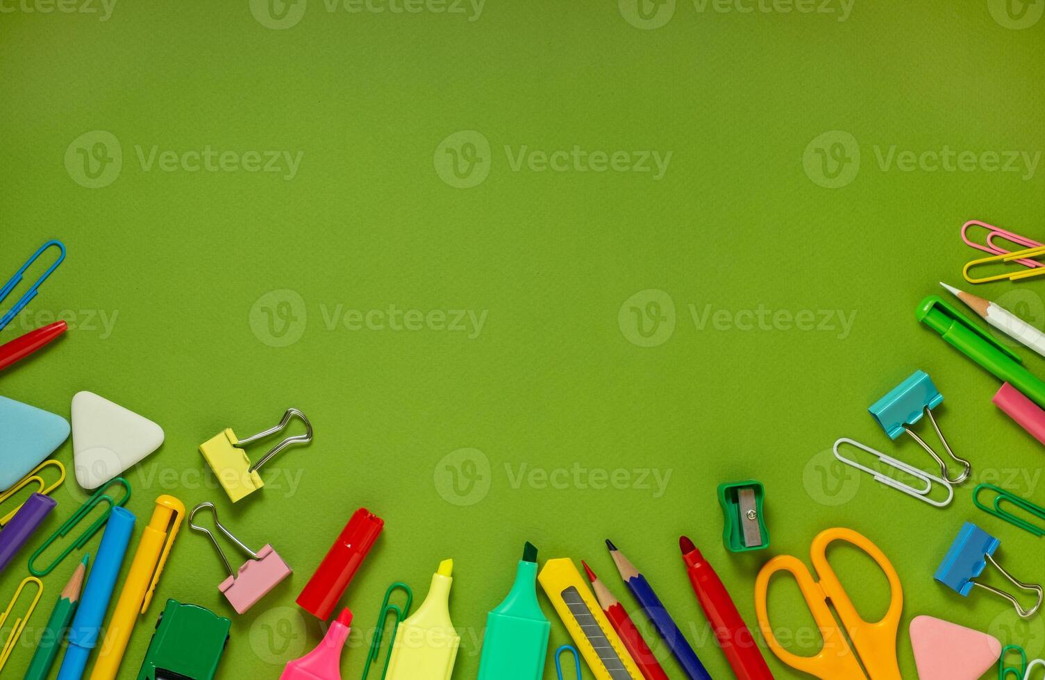 School office supplies on a desk with copy space. Back to school concept. School supplies on green background. Back 2 school concept photo