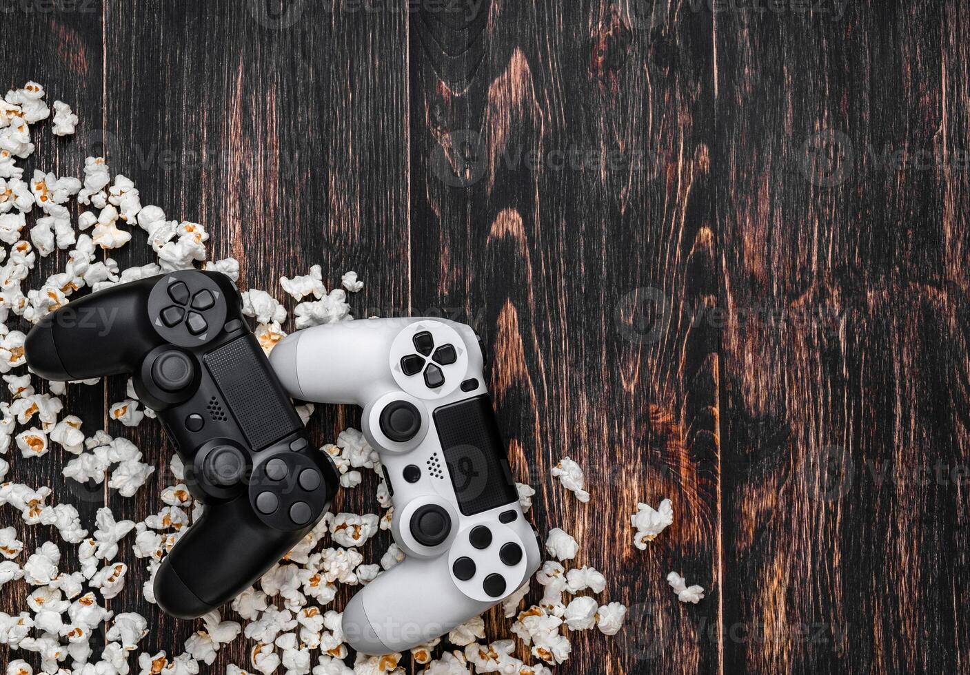 gamepad and popcorn on a wooden background photo