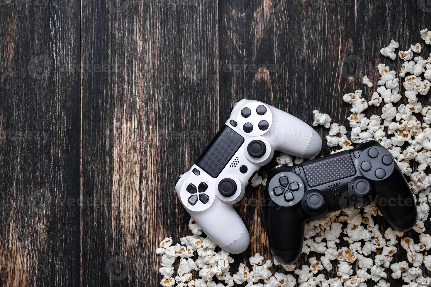 gamepad and popcorn on a wooden background photo