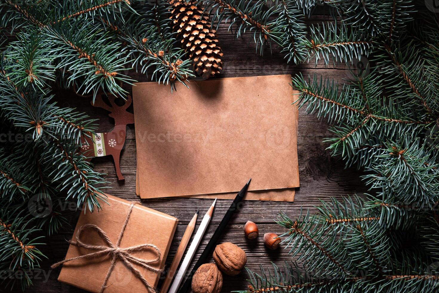A frame of fir branches and gift paper box tied with twine. Christmas card blank. photo