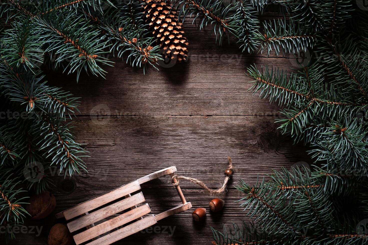 Christmas frame from fir branches on a background of an old gray board around an open notebook with blank sheets. Frame of fir branches. Christmas card blank concept. photo
