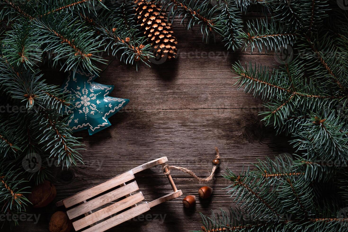 Christmas frame from fir branches on a background of an old gray board around an open notebook with blank sheets. Frame of fir branches. Christmas card blank concept. photo