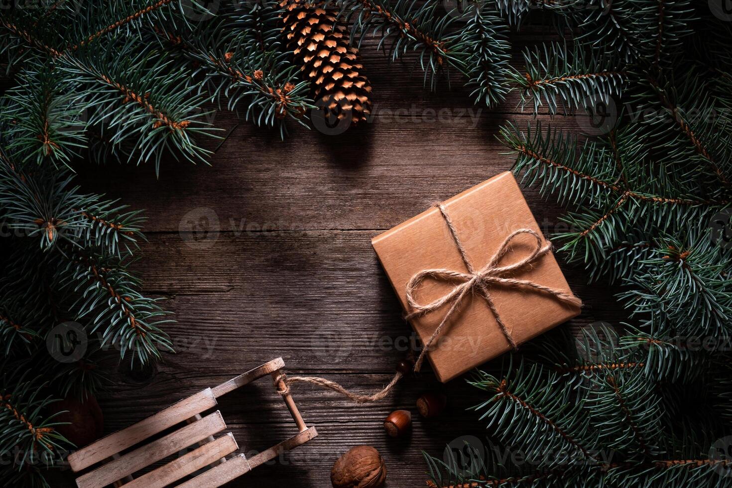 A frame of fir branches and gift paper box tied with twine. Christmas card blank. photo