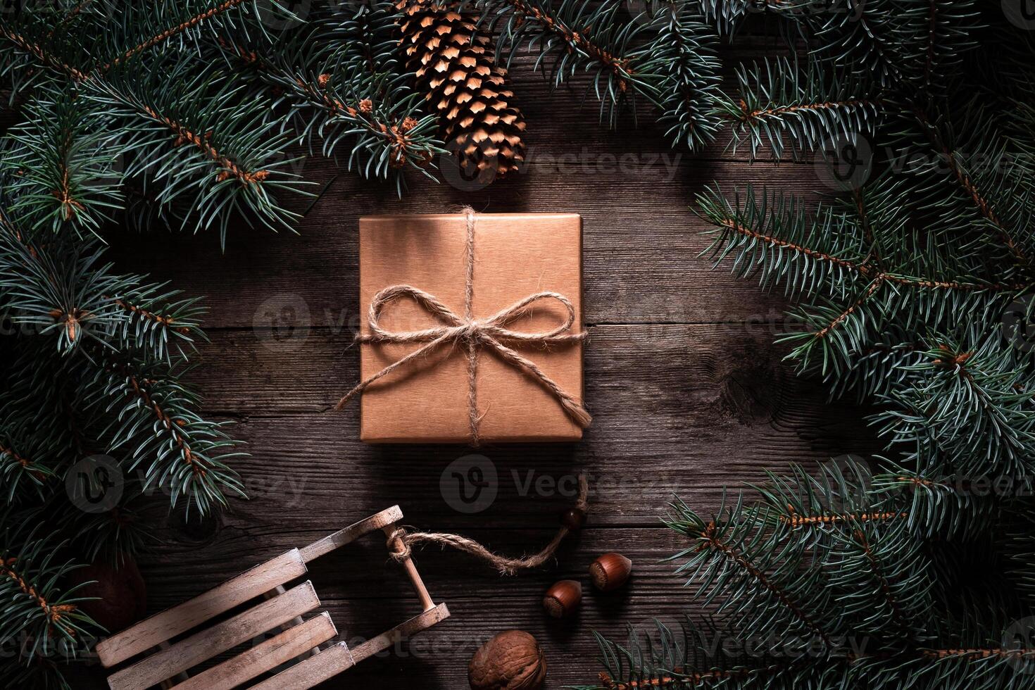 A frame of fir branches and gift paper box tied with twine. Christmas card blank. photo
