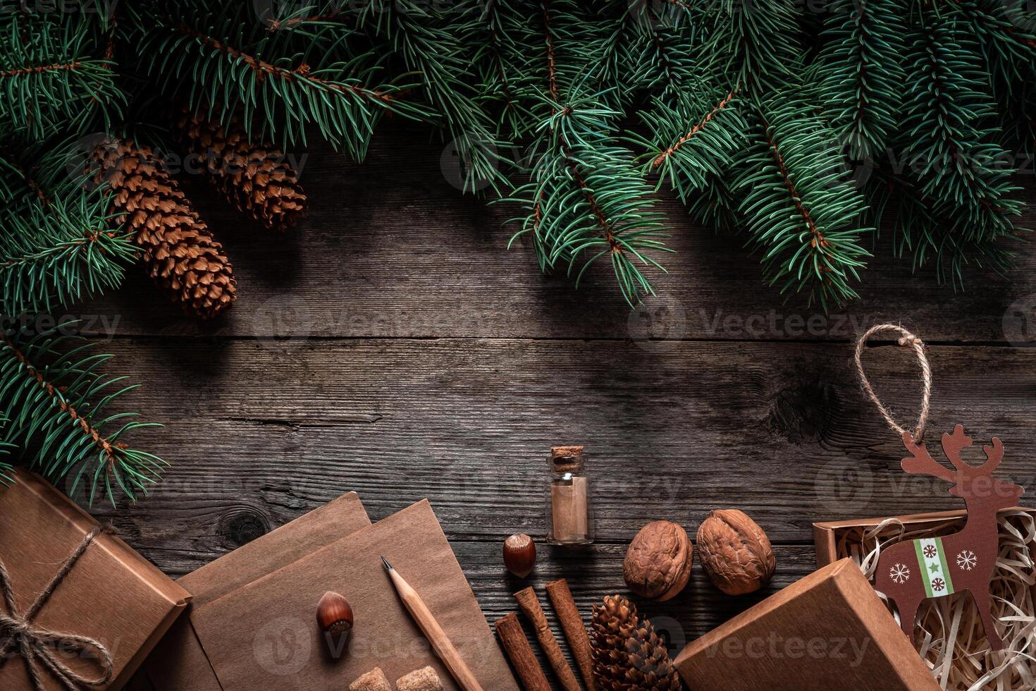 Christmas green frame from fir branches on a vintage gray board background. Frame of fir branches. Christmas card blank. photo