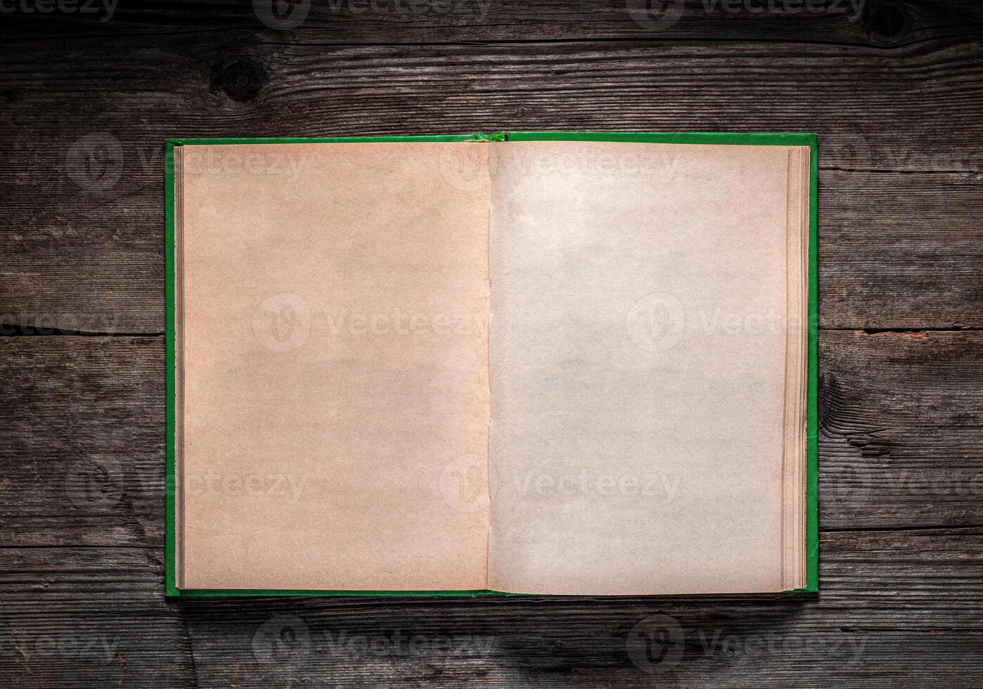 Vintage book, open, on old wooden table, with clipping path. Open Book blank on old wooden background. book with blank pages photo