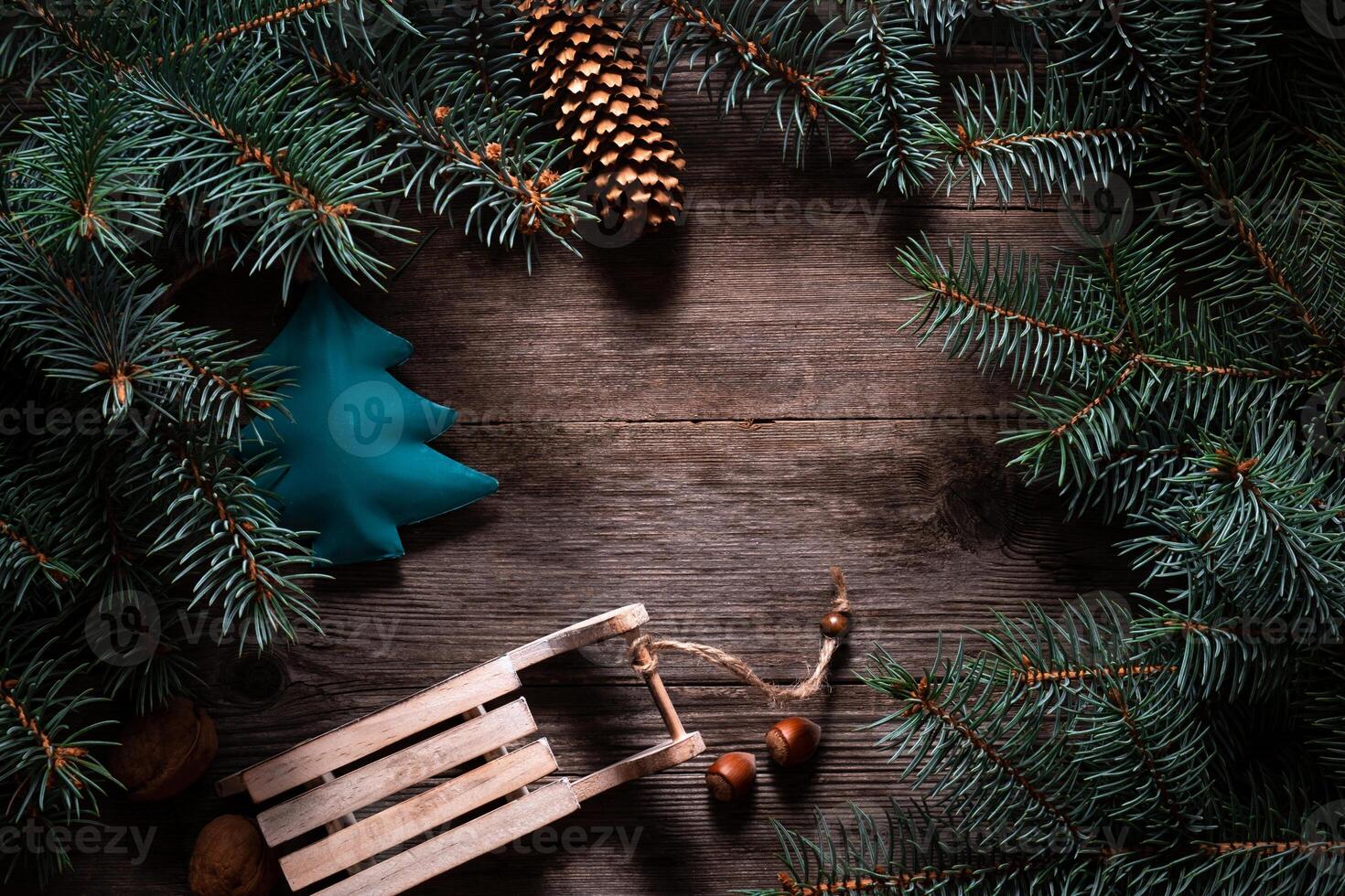 Christmas frame from fir branches on a background of an old gray board around an open notebook with blank sheets. Frame of fir branches. Christmas card blank concept. photo
