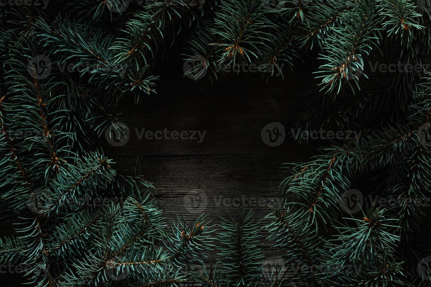 Christmas green frame from fir branches on a vintage gray board back. Frame of fir branches. Christmas card blank. photo