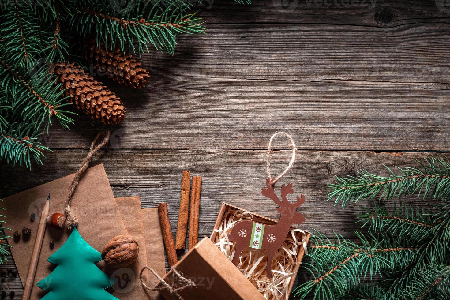 Christmas green frame from fir branches on a vintage gray board background. Frame of fir branches. Christmas card blank. photo