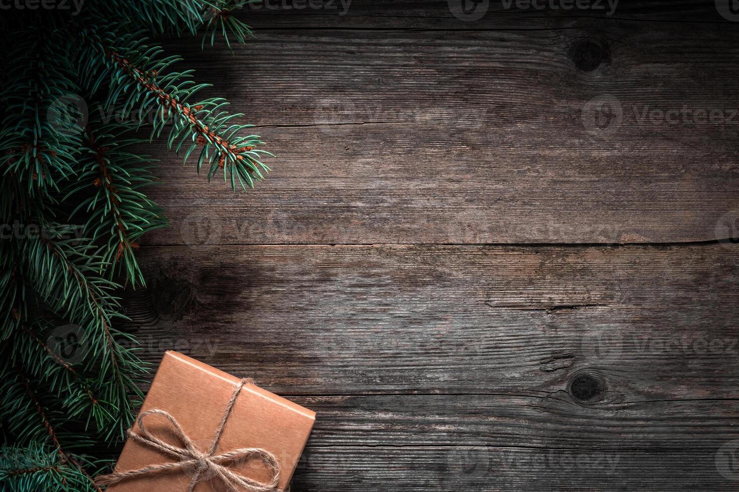 Christmas green frame from fir branches on a vintage gray board background. Frame of fir branches. Christmas card blank. photo