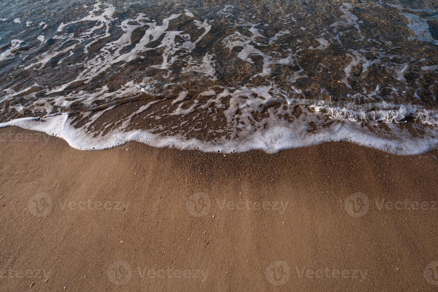 Seascape. Waves running on the sandy shore. Shore of the sea or ocean on a nice day. Vacation and relaxation by the sea. photo
