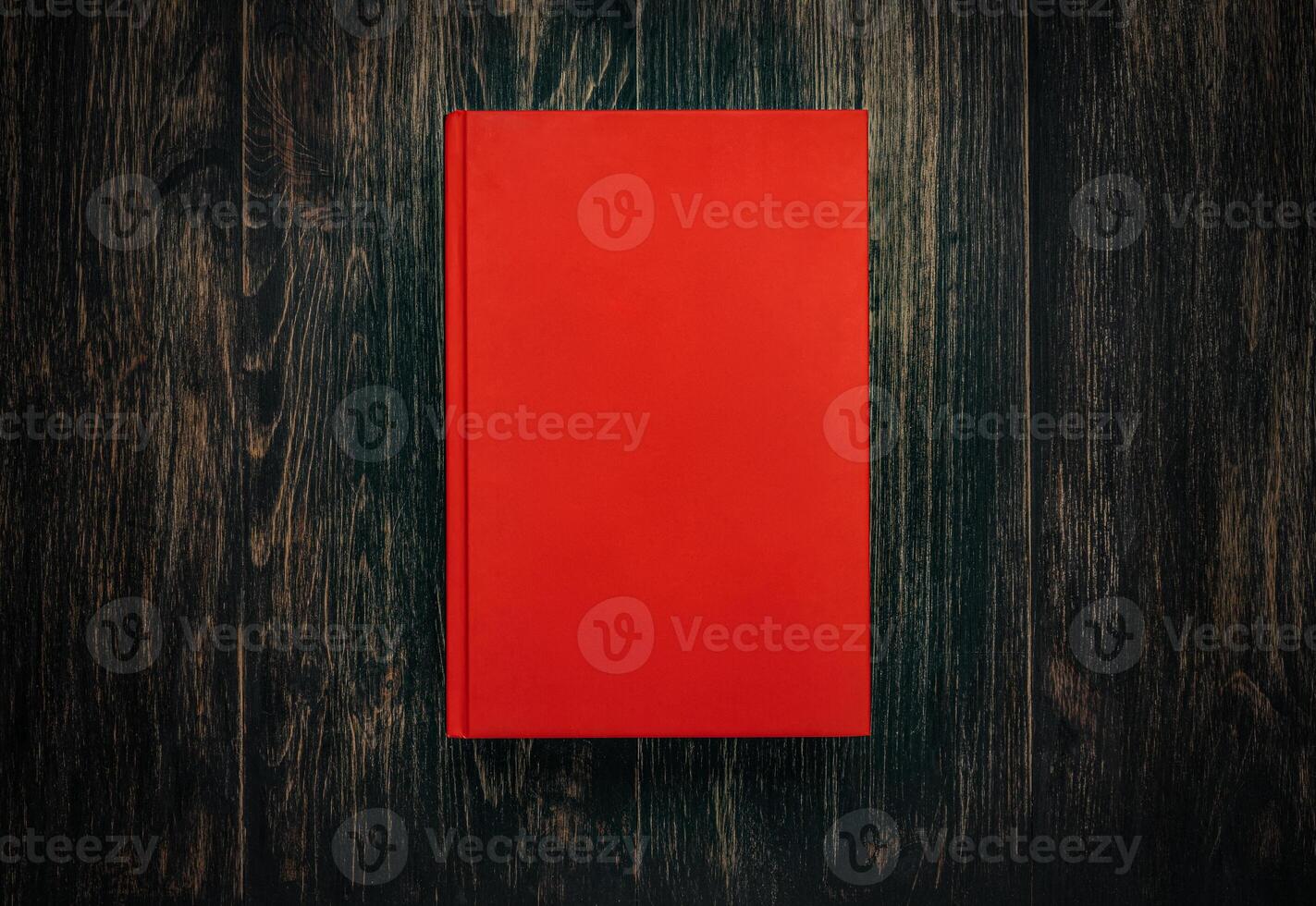 Closed book on vintage wooden background. Book on the wooden table. Closed book with empty cover laying on wooden table. photo