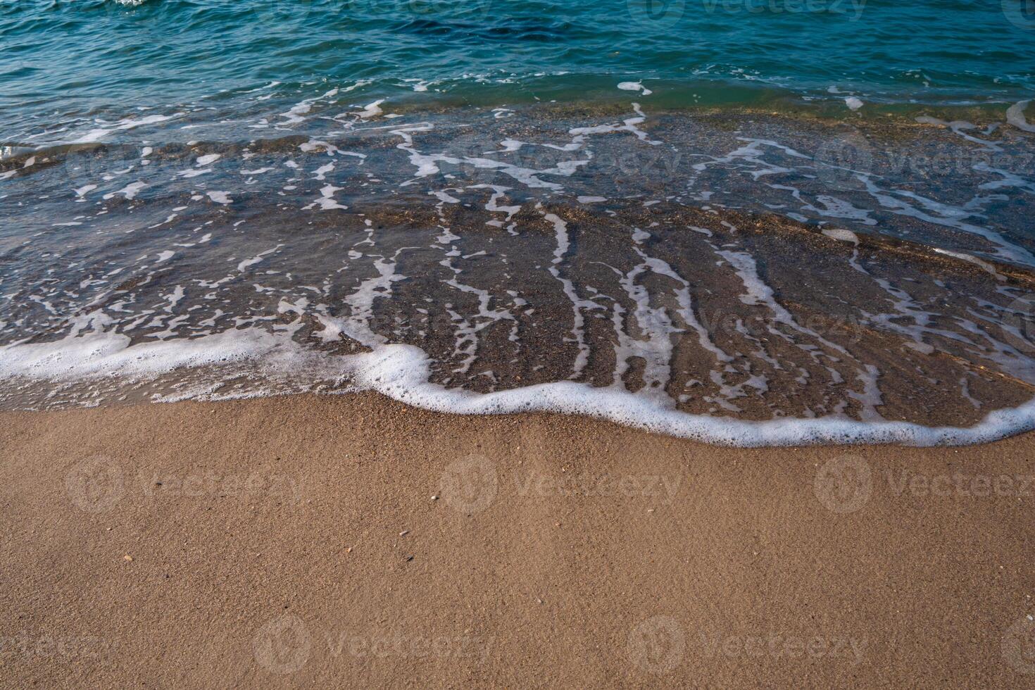Seascape. Waves running on the sandy shore. Shore of the sea or ocean on a nice day. Vacation and relaxation by the sea. photo