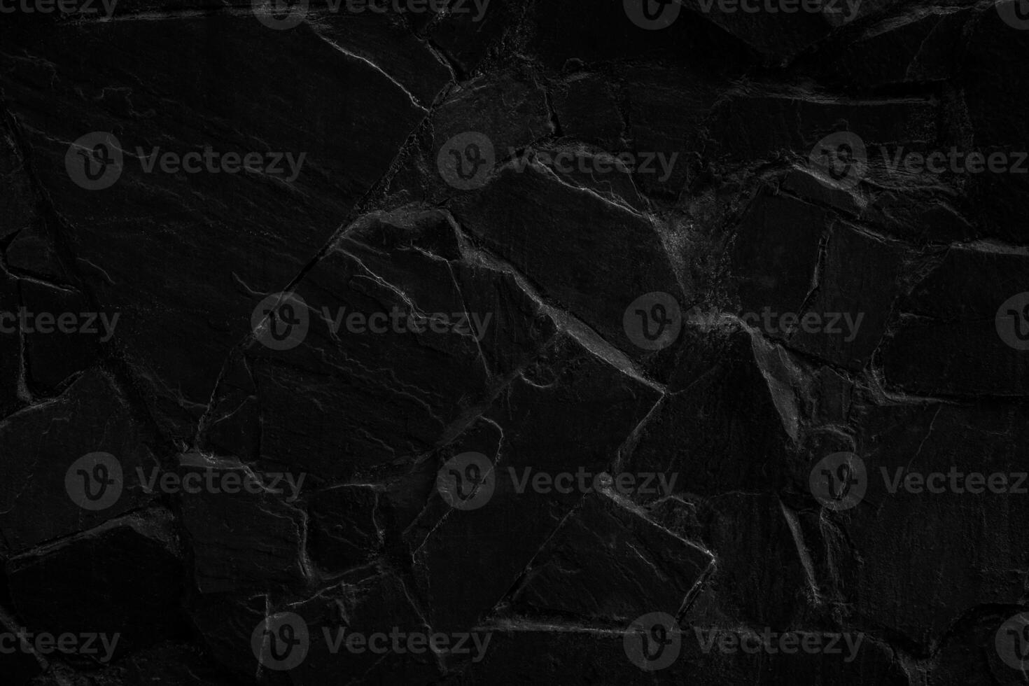 Black stone texture. The stones are tight to each other. Dark stone floor or wall. photo