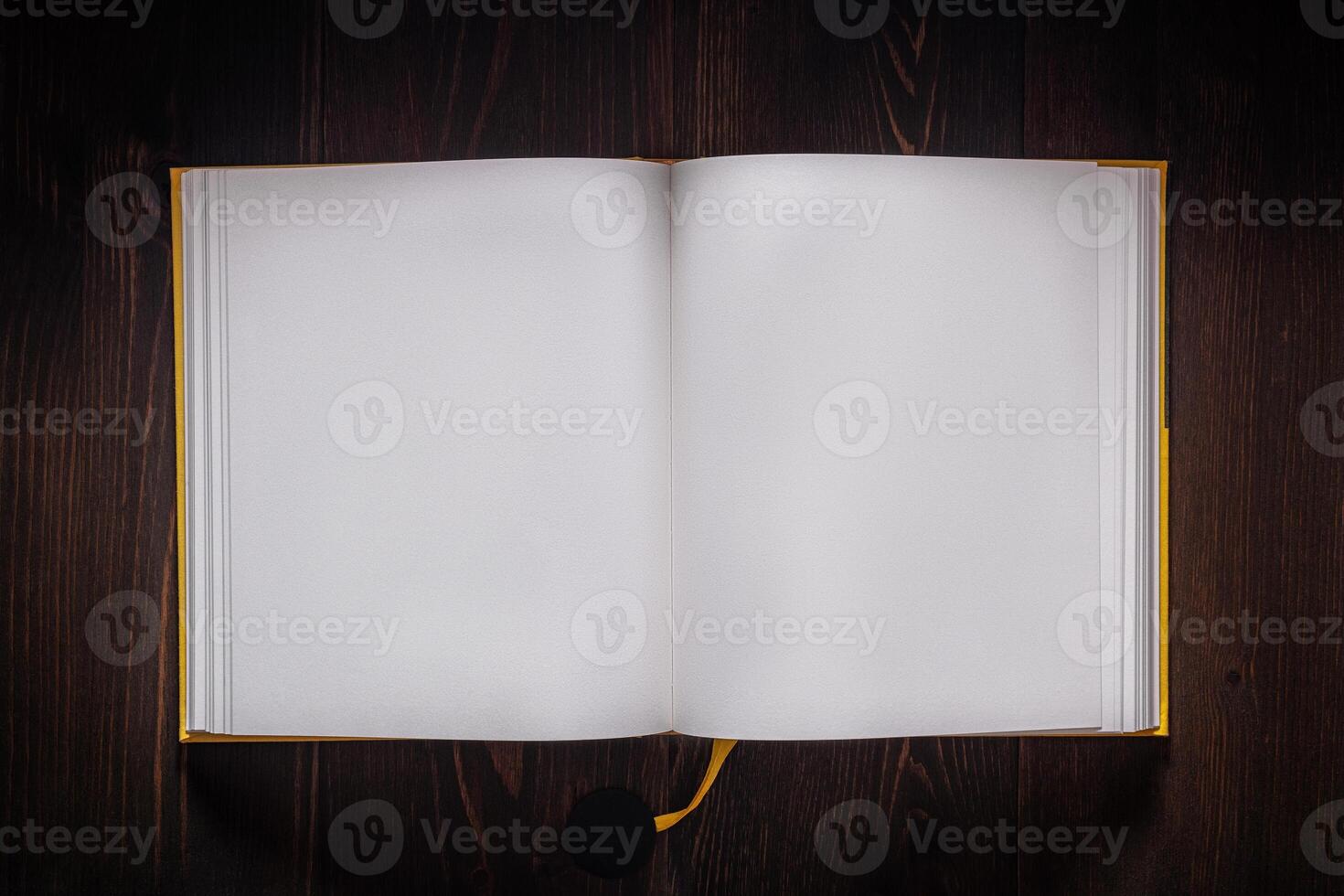 Open book blank on old wooden table. Book with blank pages on dark back. photo