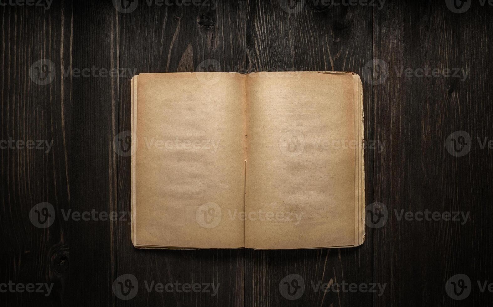 Vintage book, open, on old wooden table, with clipping path. Open Book blank on old wooden background. book with blank pages photo