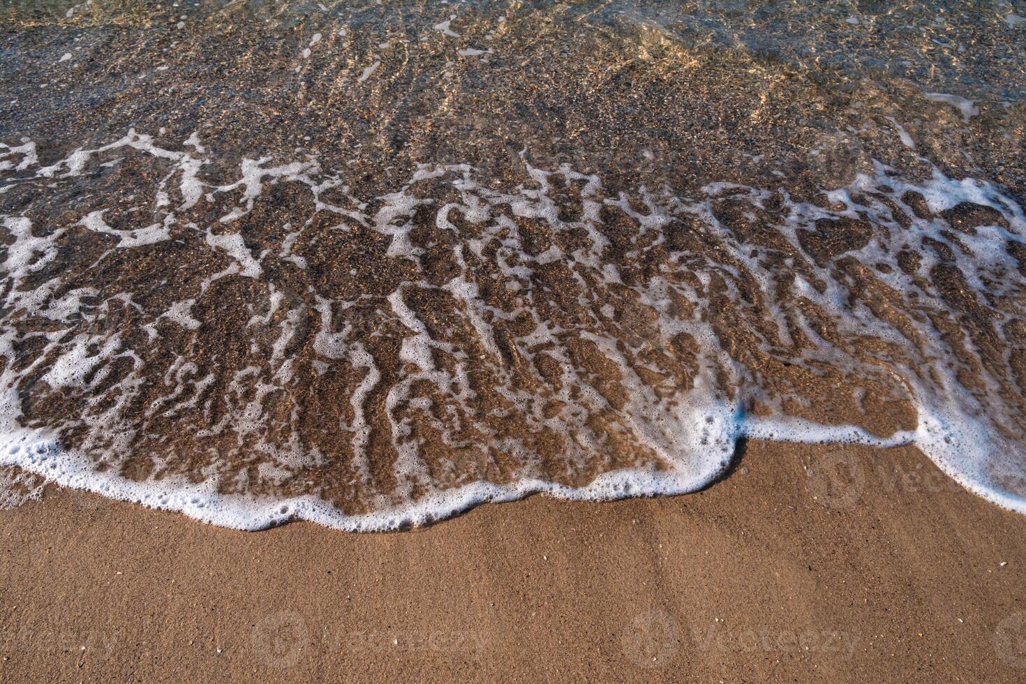 Seascape. Waves running on the sandy shore. Shore of the sea or ocean on a nice day. Vacation and relaxation by the sea. photo