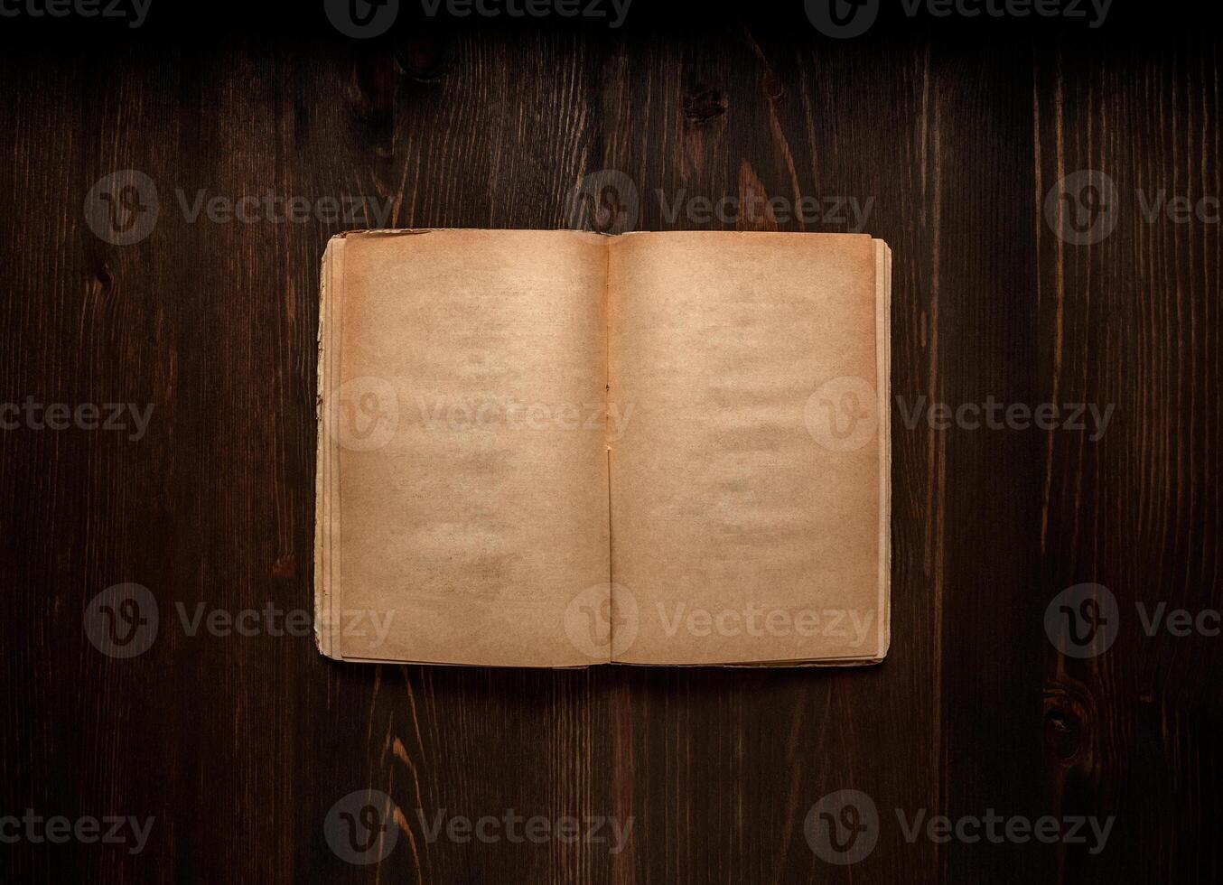 Vintage book, open, on old wooden table, with clipping path. Open Book blank on old wooden background. book with blank pages photo