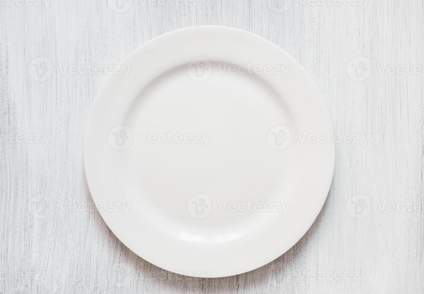 White round plate on white background. Empty white plate on white background. photo
