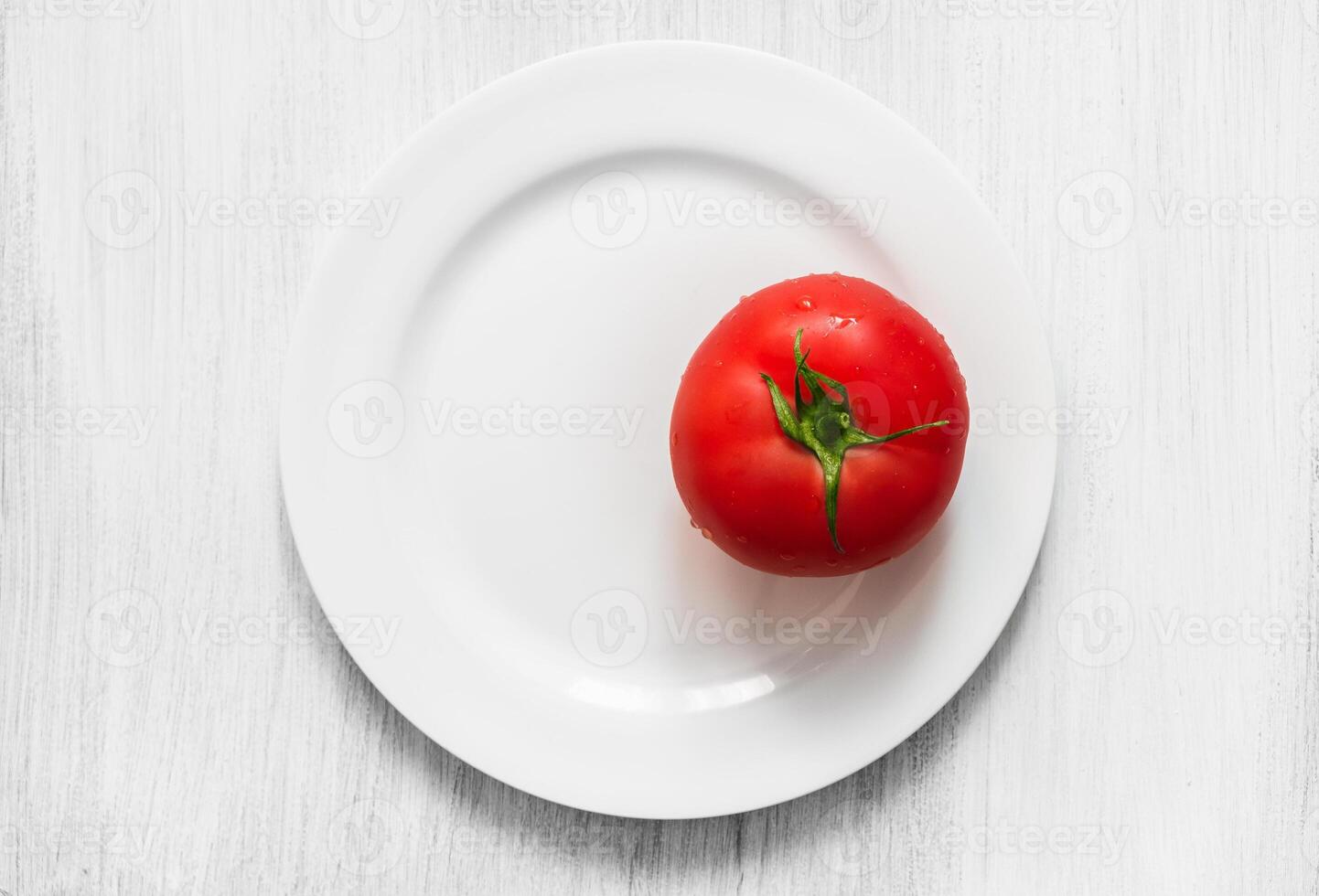 Red tomato on a plate photo