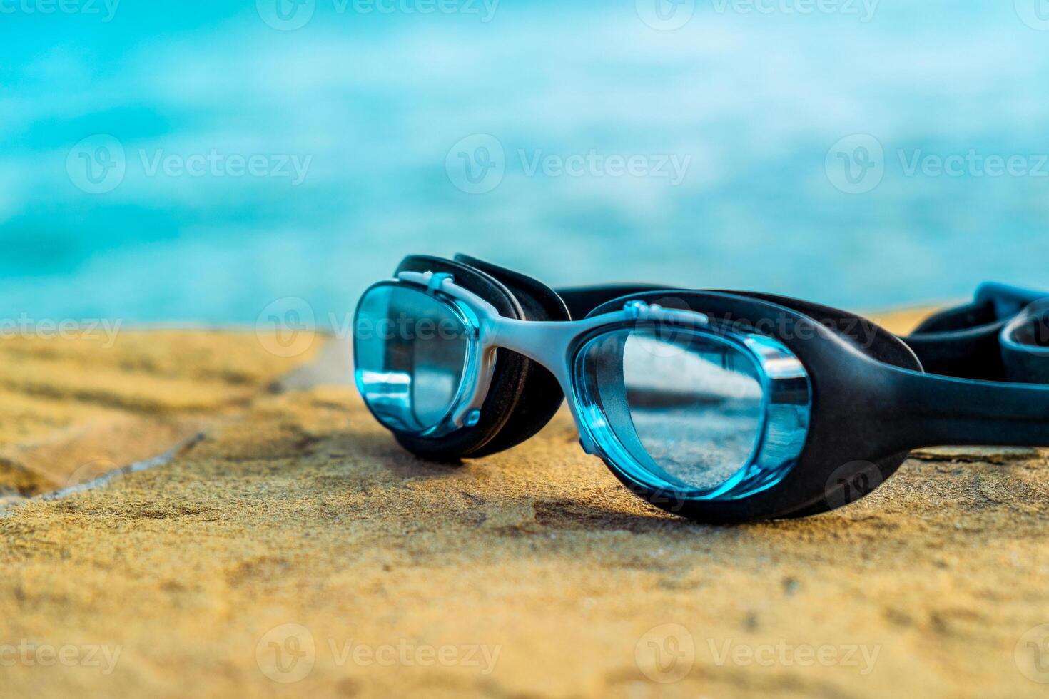 Blue diving glasses on the beach photo