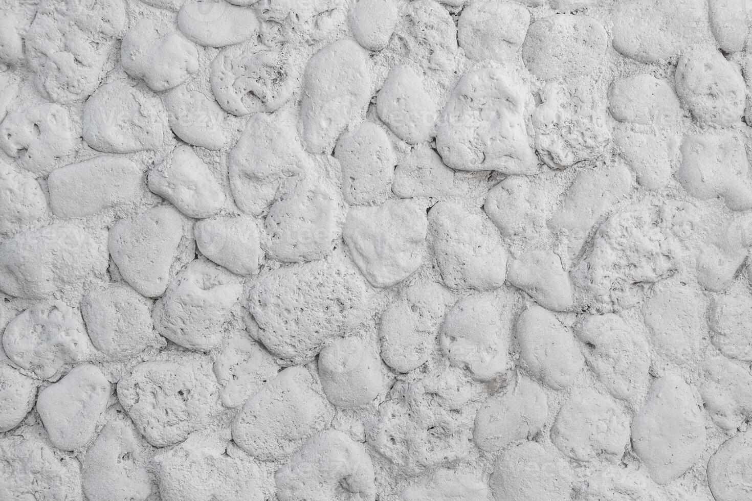 White wall made of natural stone. Texture light stone back. photo