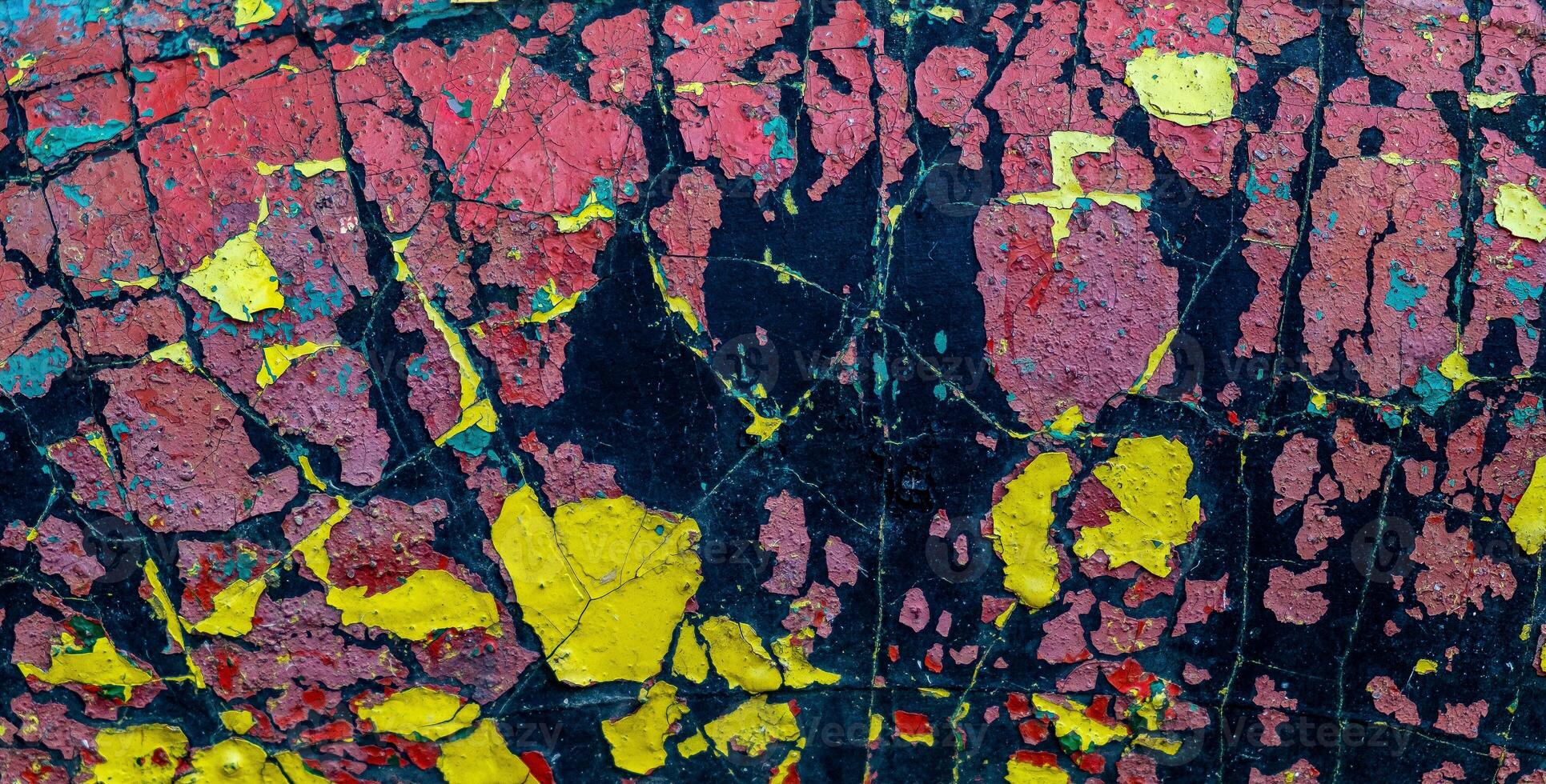 Abstract vintage multicolored surface in cracked paint. Paint of different colors on the aged and cracked back photo