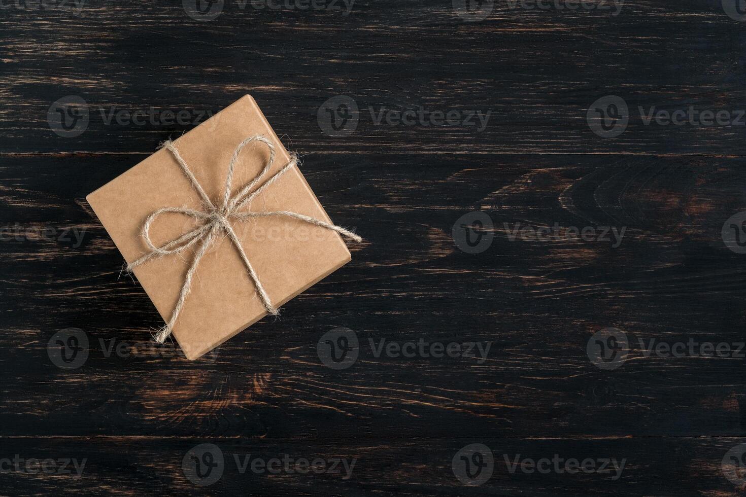 gift box tied with string on a dark background photo