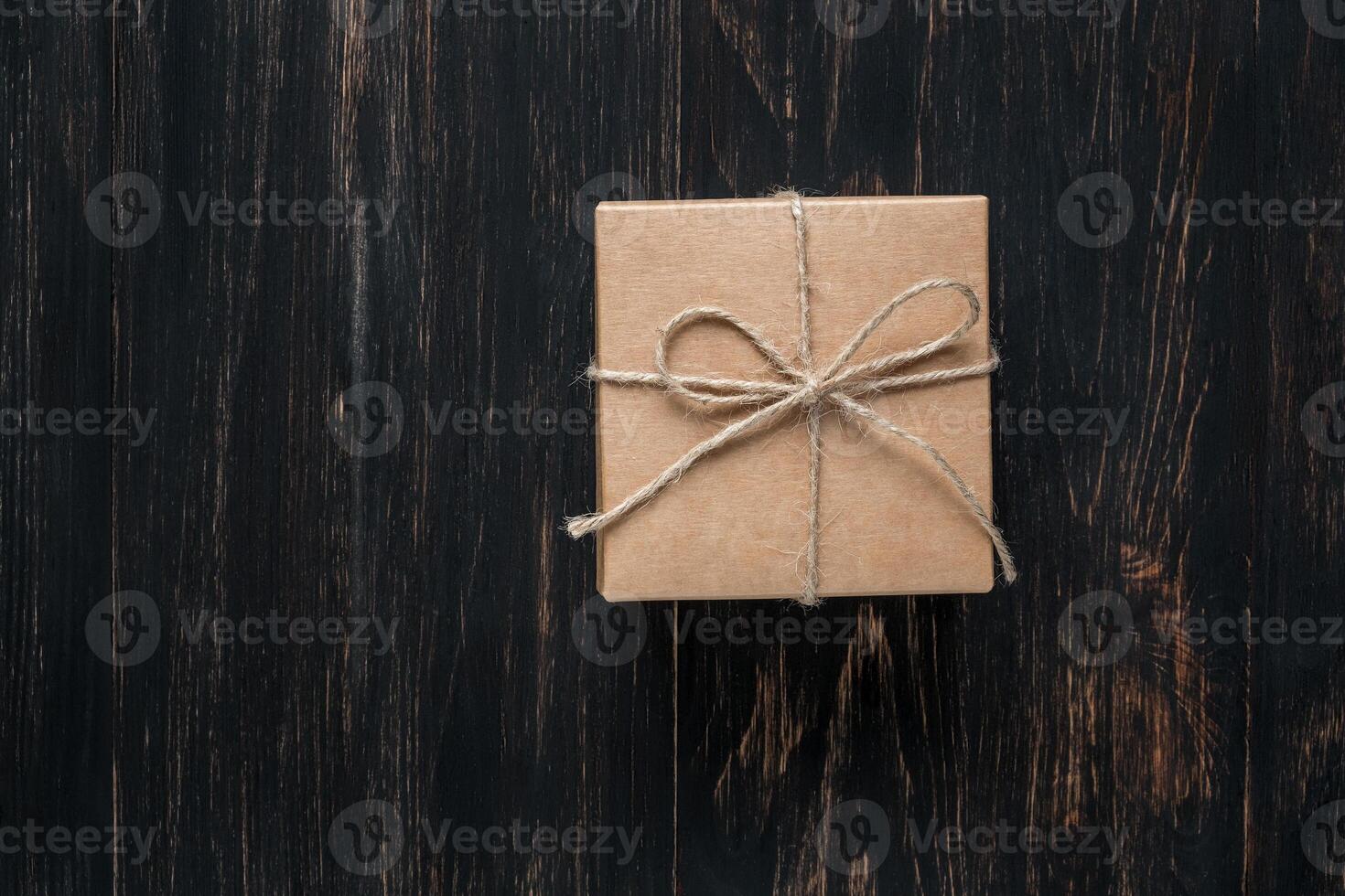 gift box tied with string on a dark background photo