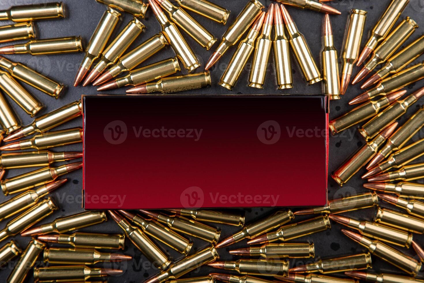 Background from rifle cartridges on a gray metal back. A box of cartridges. Copy space for text in the center of the image in the form of a rectangle. photo