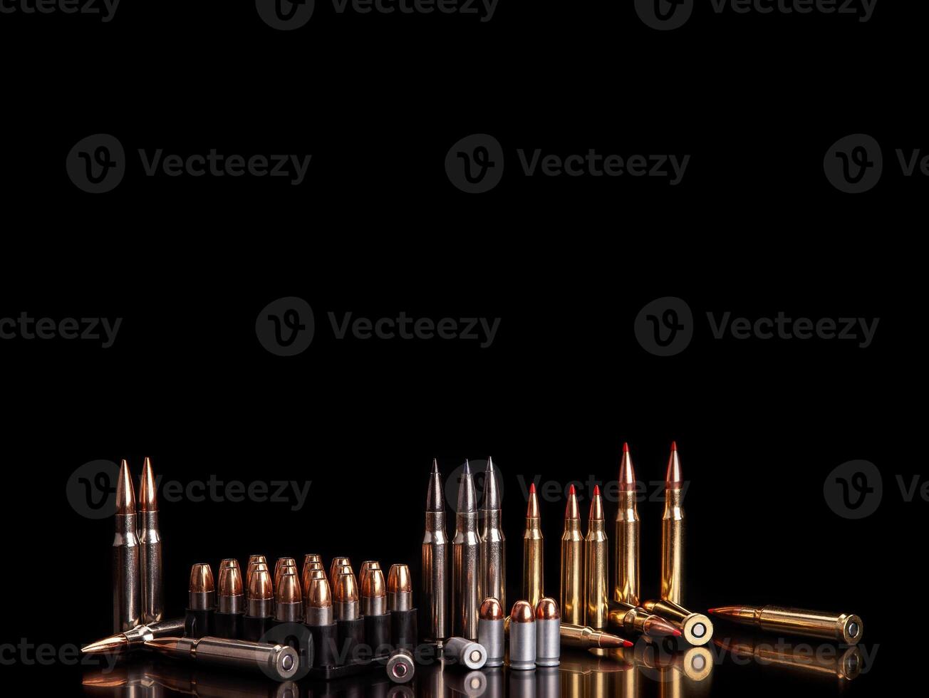 Bullet isolated on black background with reflexion. Rifle bullets close-up on black back. Cartridges for rifle and carbine on a black. photo