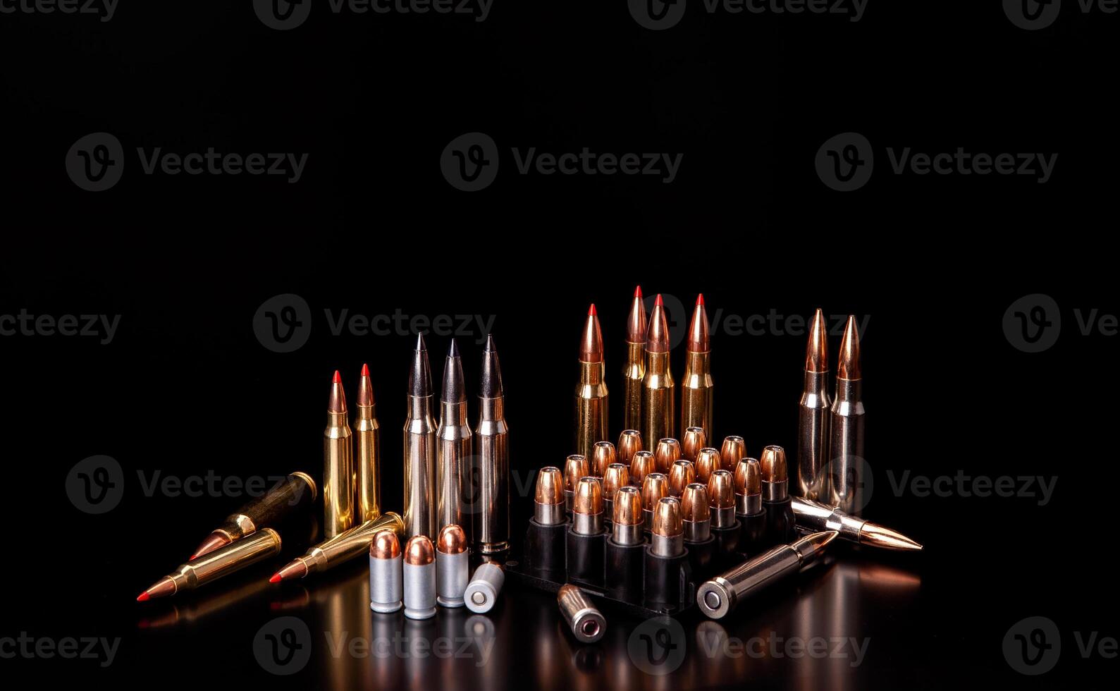 Bullet isolated on black background with reflexion. Rifle bullets close-up on black back. Cartridges for rifle and carbine on a black. photo