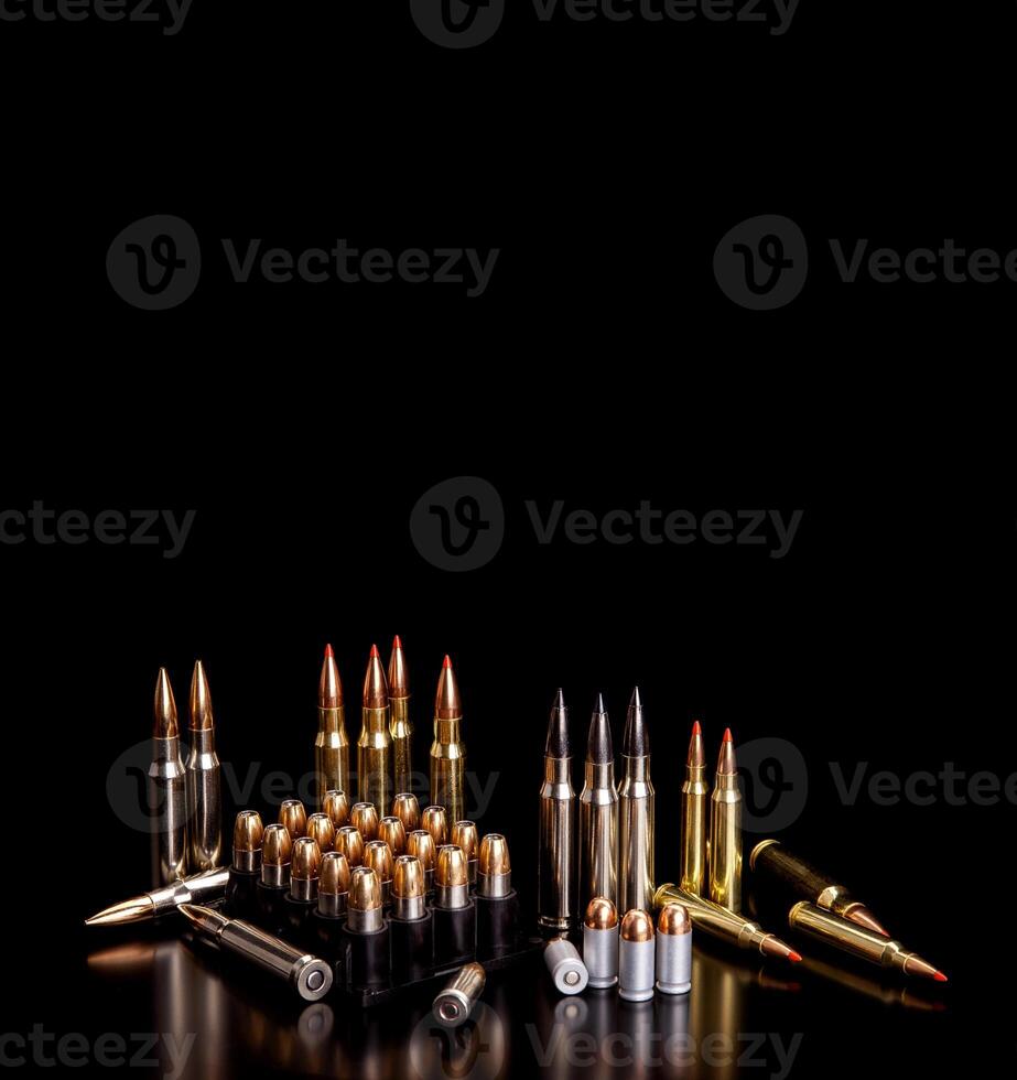 Bullet isolated on black background with reflexion. Rifle bullets close-up on black back. Cartridges for rifle and carbine on a black. photo